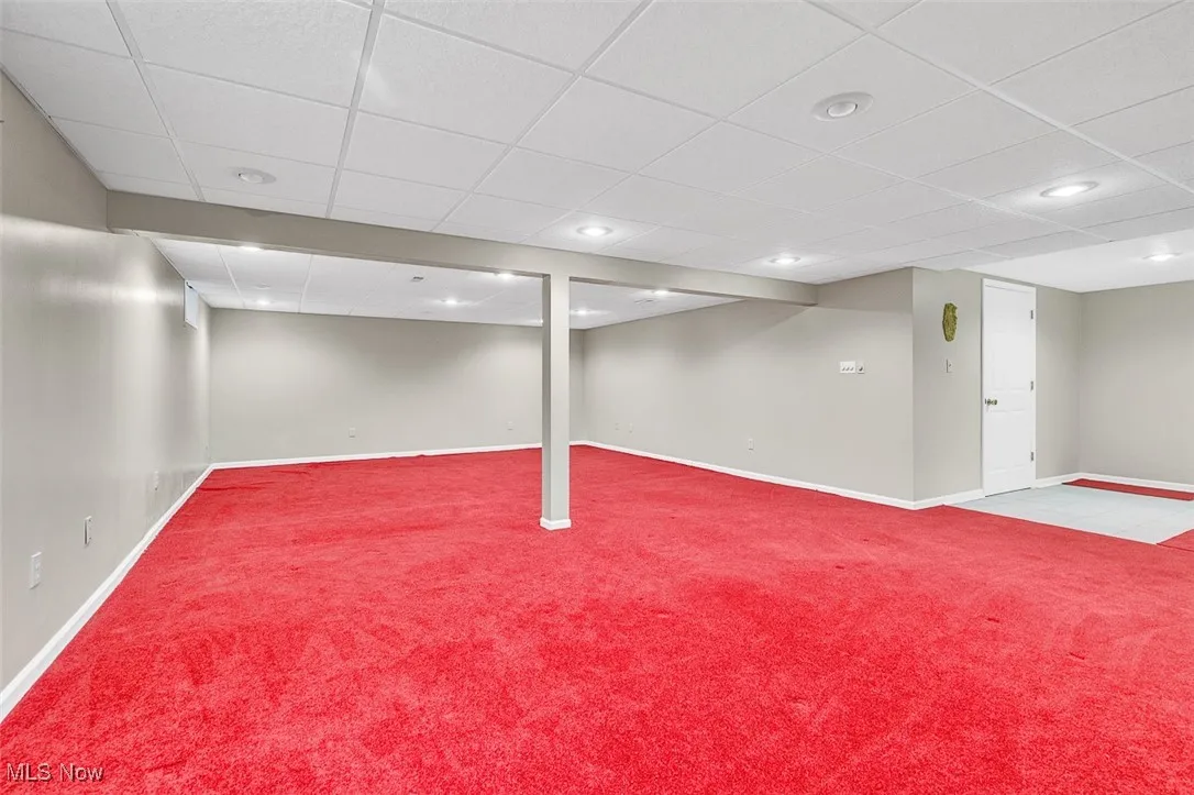 Finished basement with a drop ceiling, carpet floors, and recessed lighting