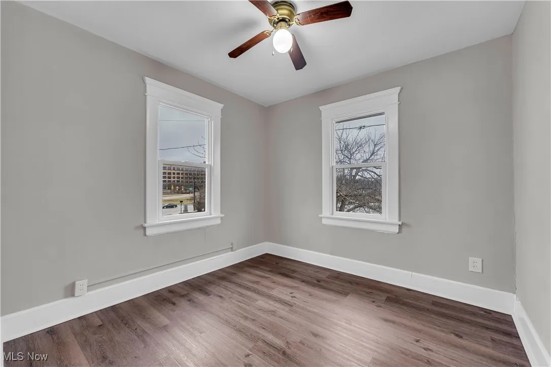Unfurnished room featuring wood finished floors and ceiling fan