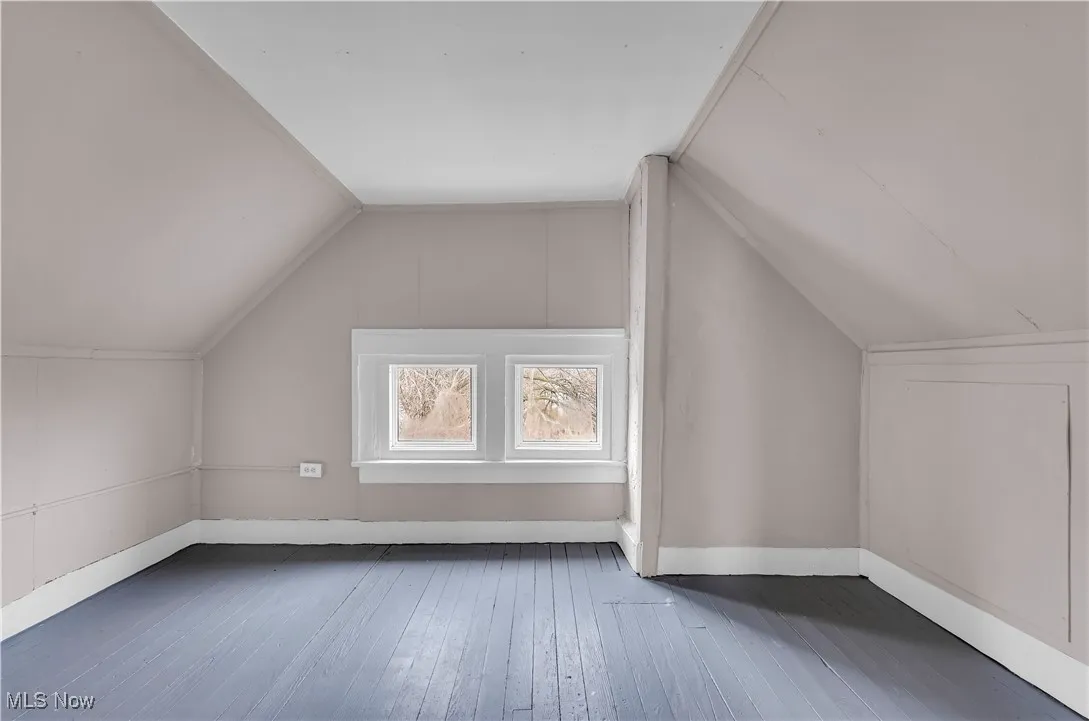 Additional living space featuring hardwood / wood-style flooring and vaulted ceiling