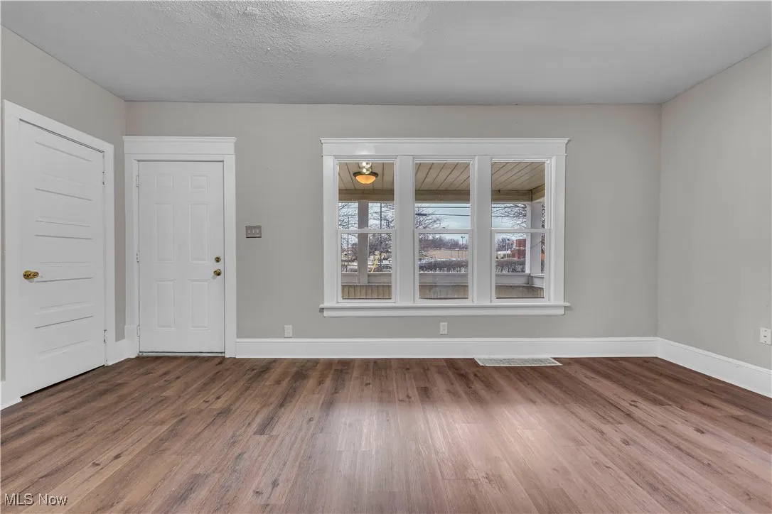 Foyer entrance with dark wood finished floors and a textured ceiling
