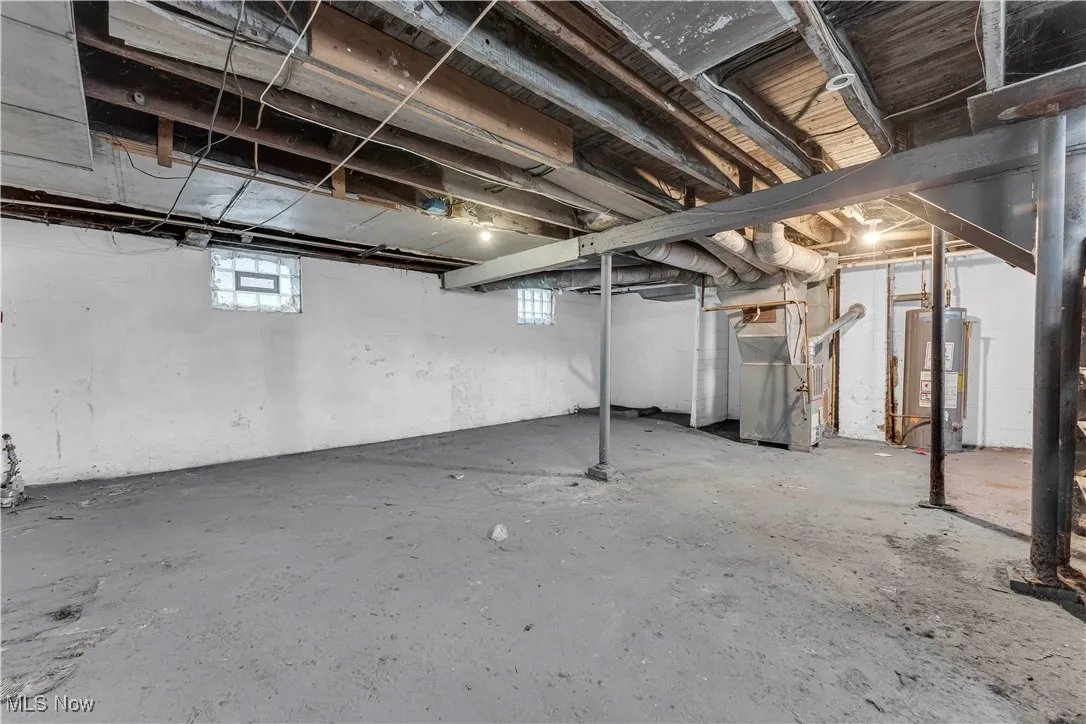 Below grade area with heating unit and gas water heater