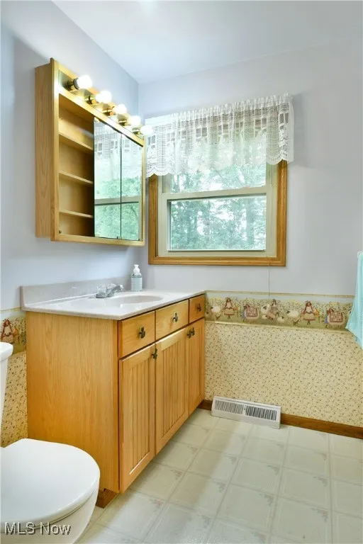 Bathroom featuring vanity and light flooring