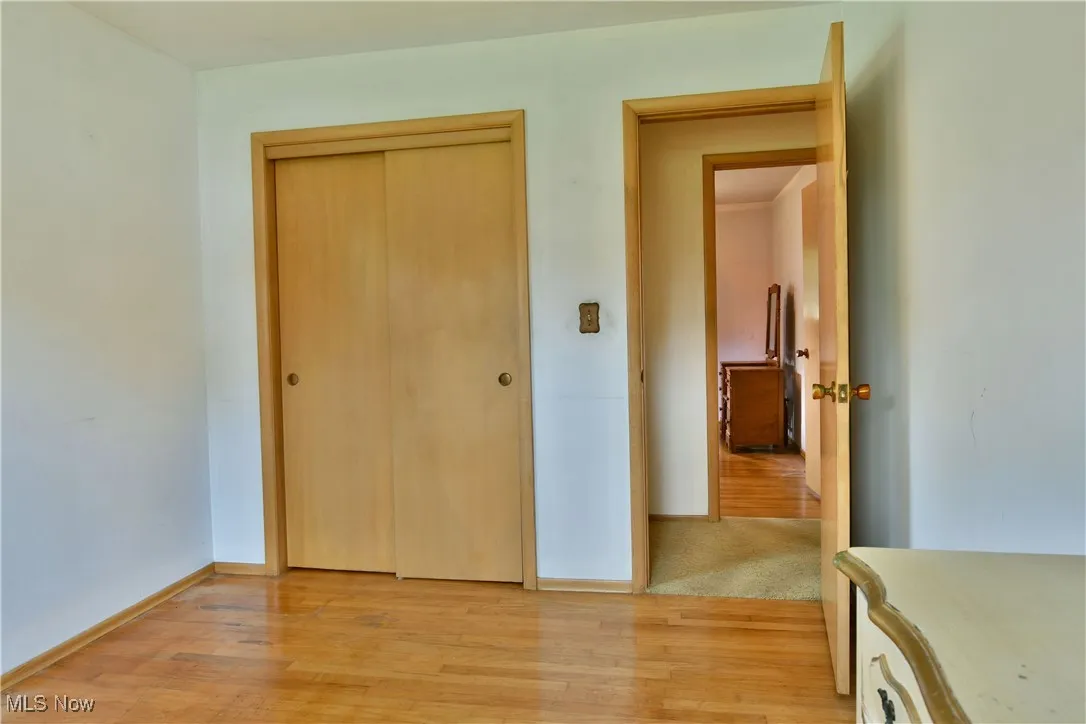 Bedroom featuring light wood finished floors and a closet