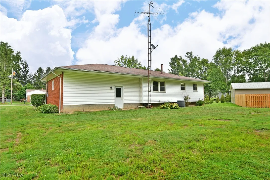 Back of property with a yard