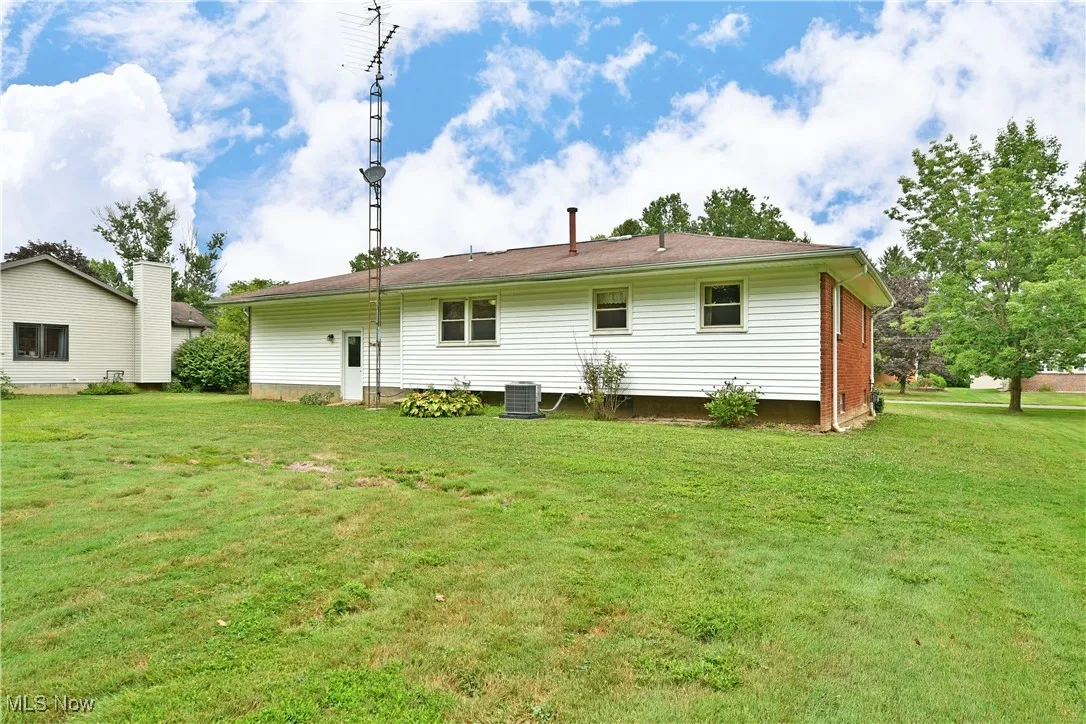 Back of property with a yard