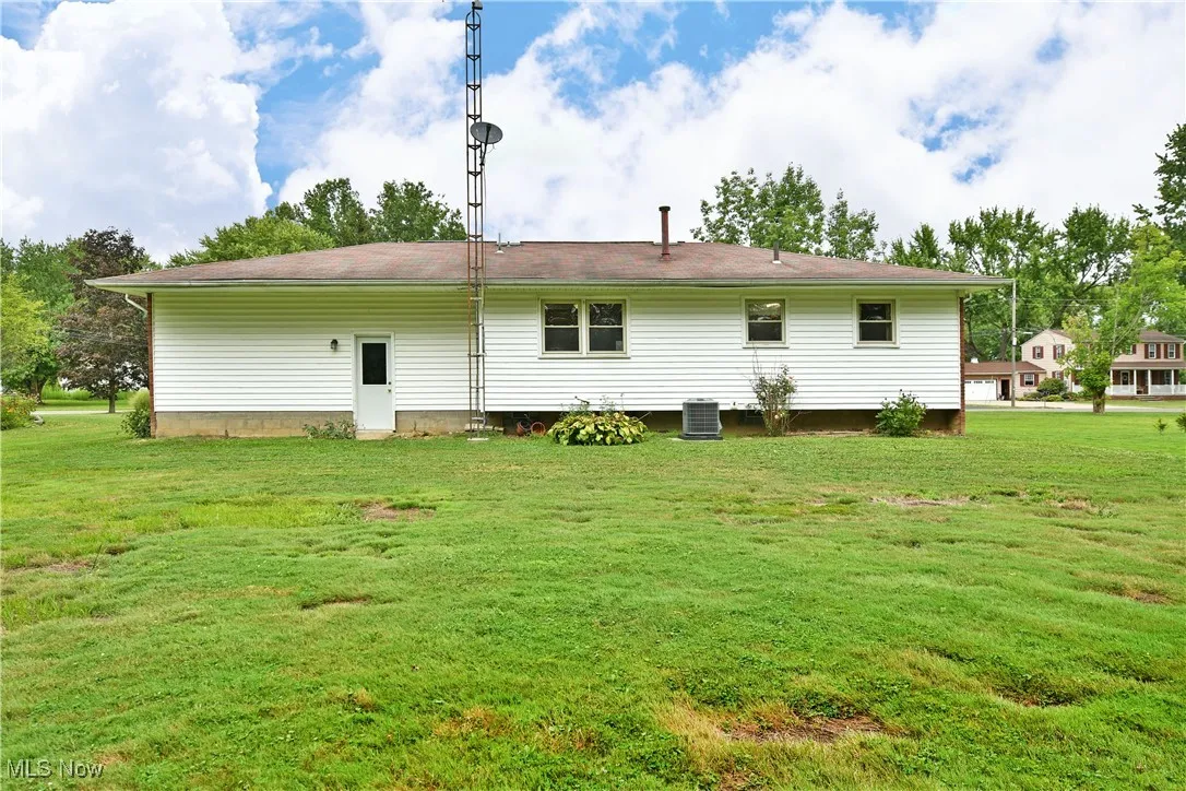 Back of property featuring a yard