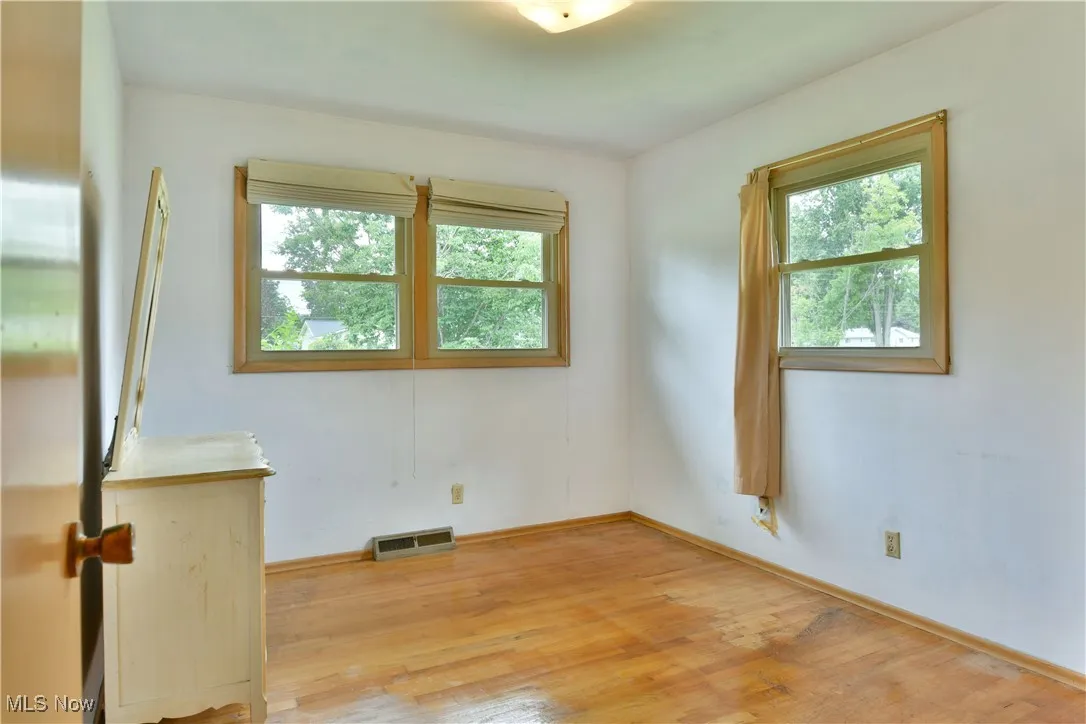 Spare room with light wood finished floors and baseboards