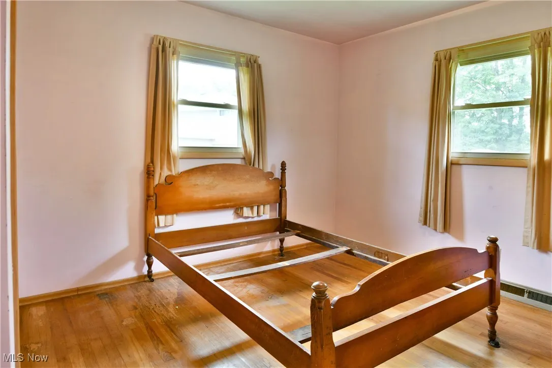 Bedroom featuring light wood-style floors and baseboards