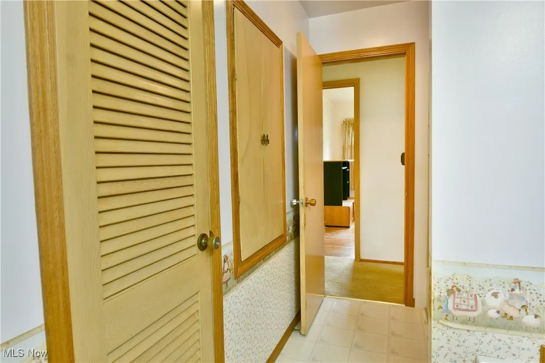 Corridor with tile patterned floors and baseboards