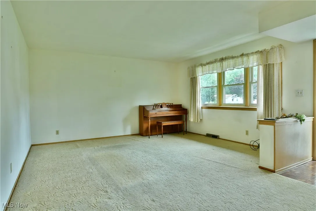 Unfurnished room featuring carpet floors and baseboards