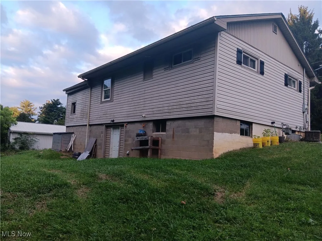 Back of property featuring a lawn