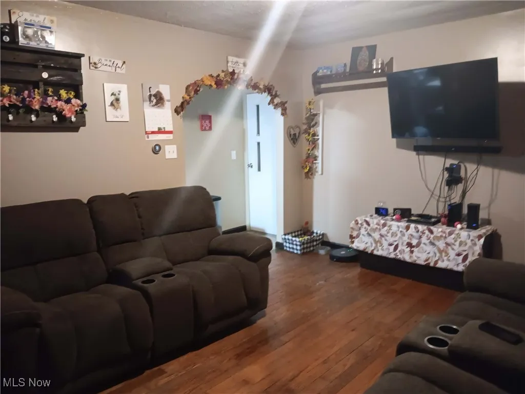 Living area with dark wood-type flooring