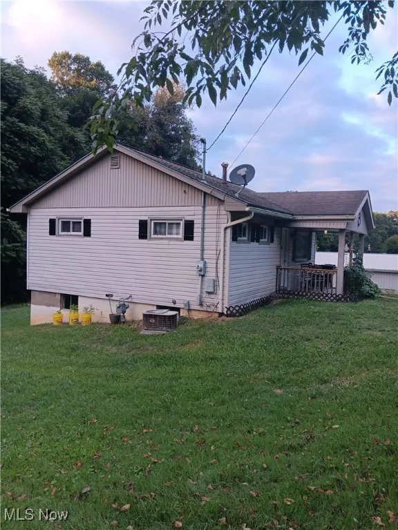 Back of property with a yard