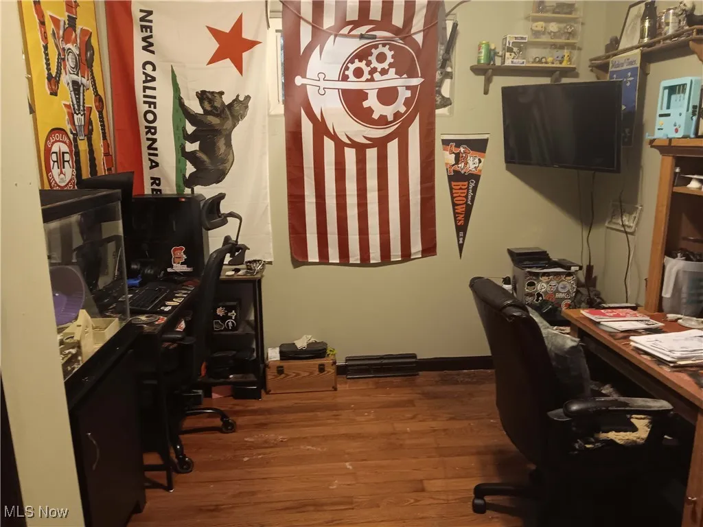 Office with dark wood finished floors and baseboards