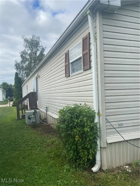 View of side of property featuring a yard