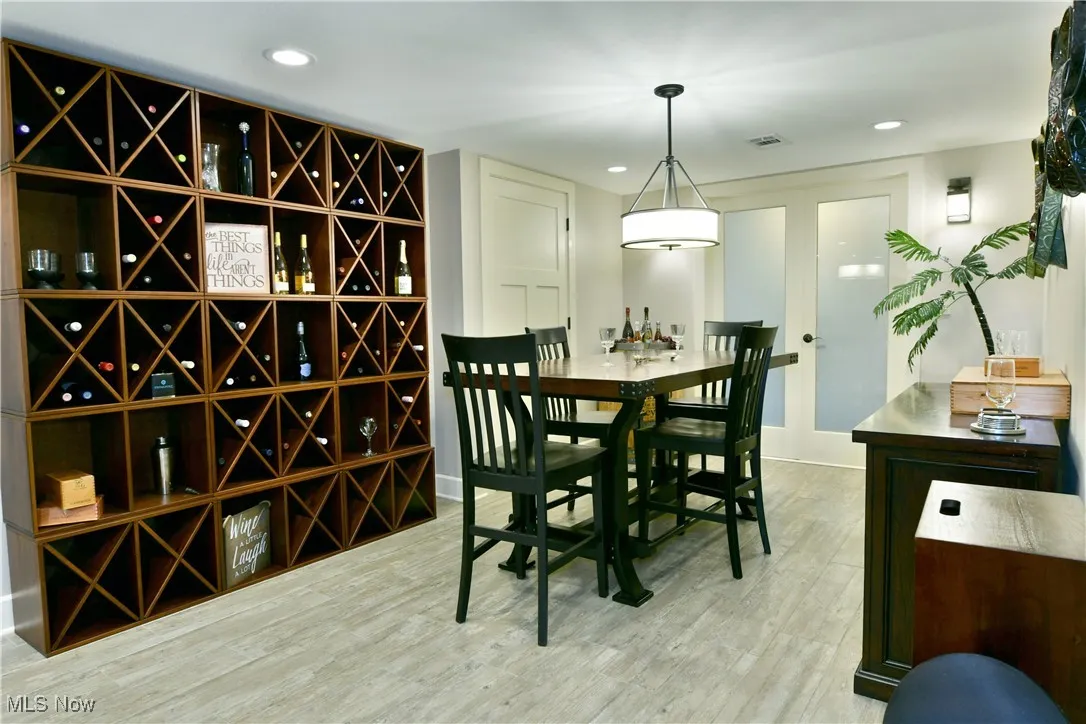 Wine area featuring light wood-style flooring and recessed lighting