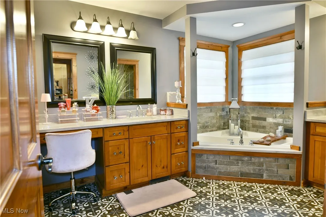Full bathroom featuring a bath and vanity