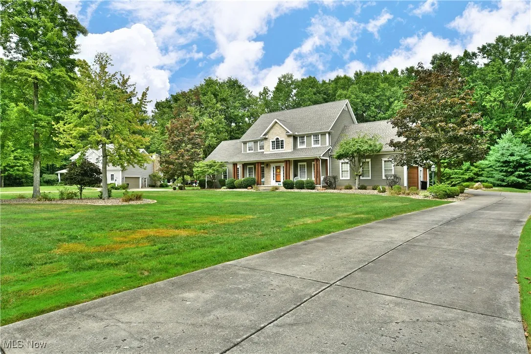 Colonial inspired home with a porch and a front yard