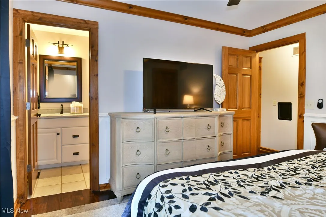 Bedroom featuring wood finished floors and a sink