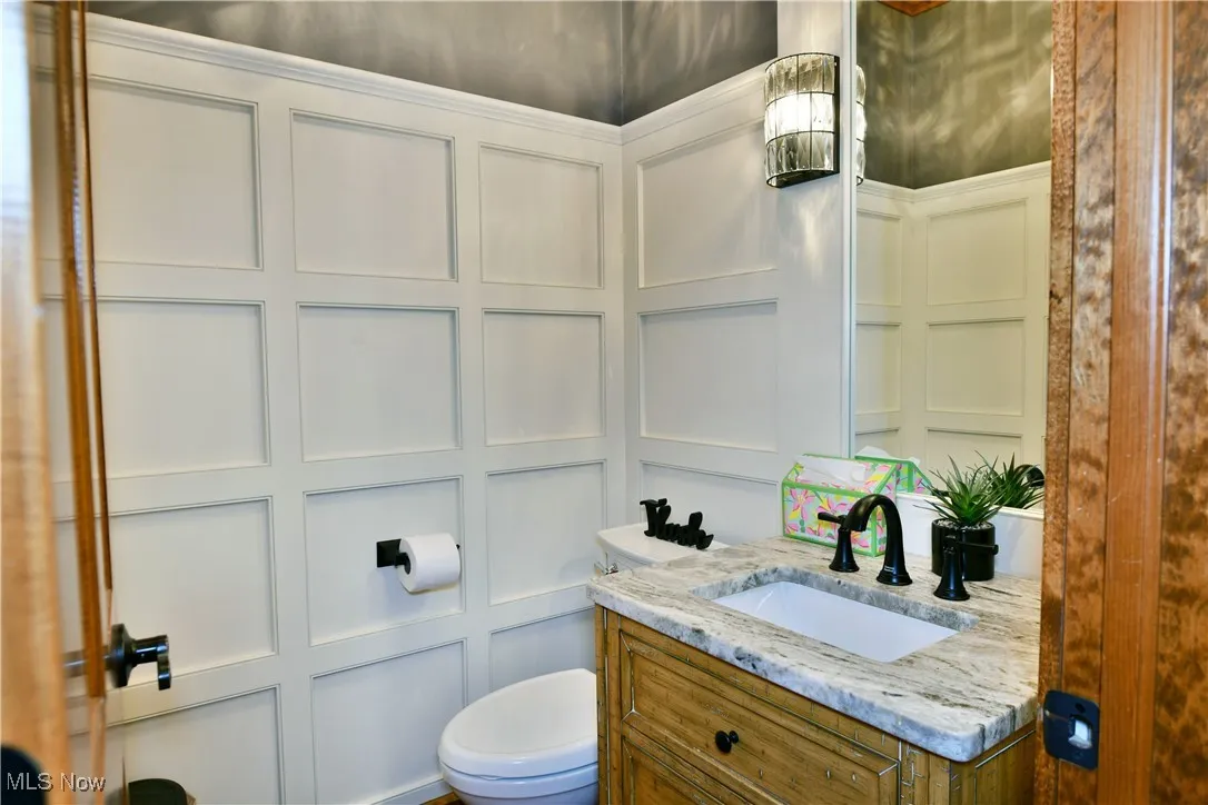 Bathroom featuring a decorative wall and vanity