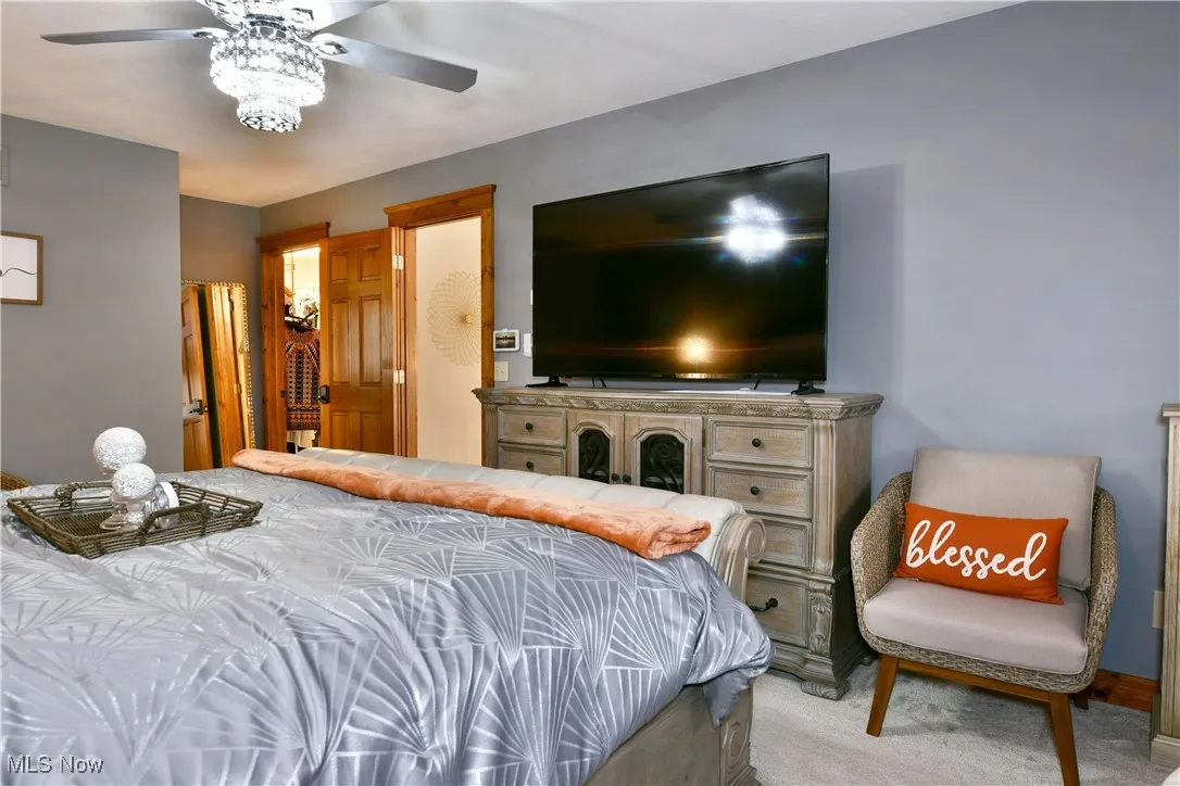 Carpeted bedroom with ceiling fan