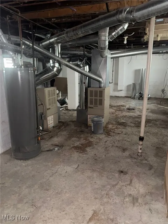 Unfinished basement with gas water heater and heating unit