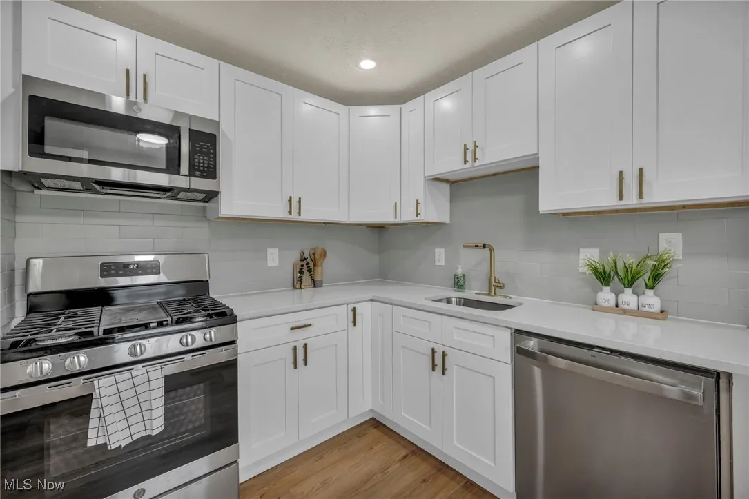 Kitchen featuring quartz countertops and new appliances