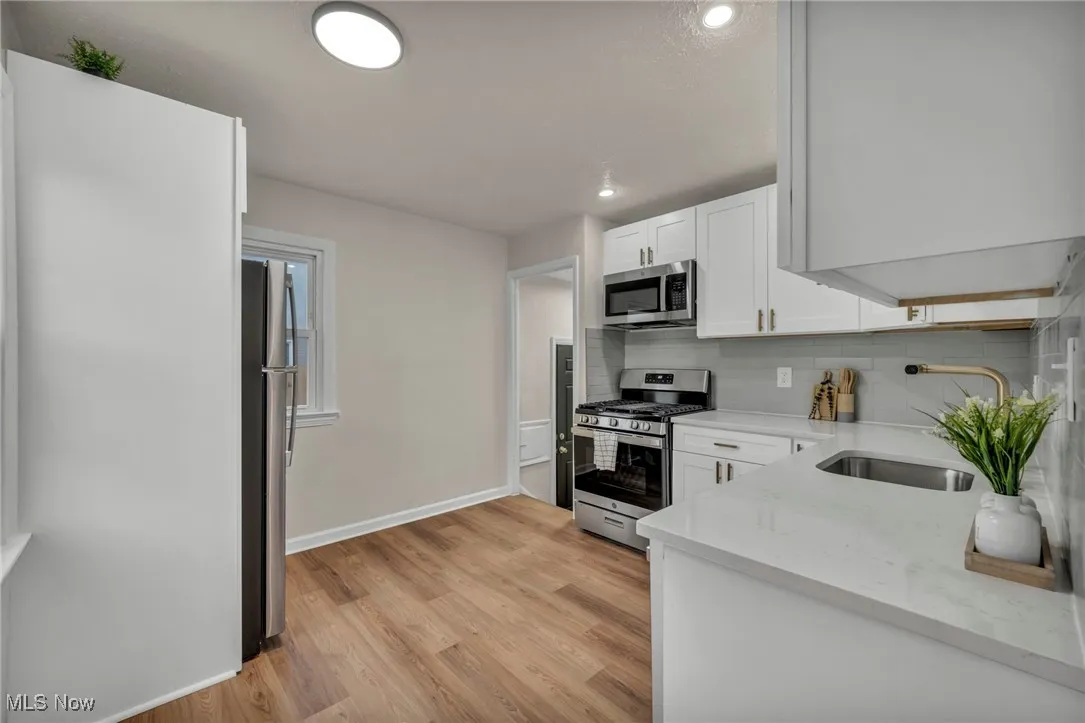 Kitchen featuring quartz countertops and new appliances