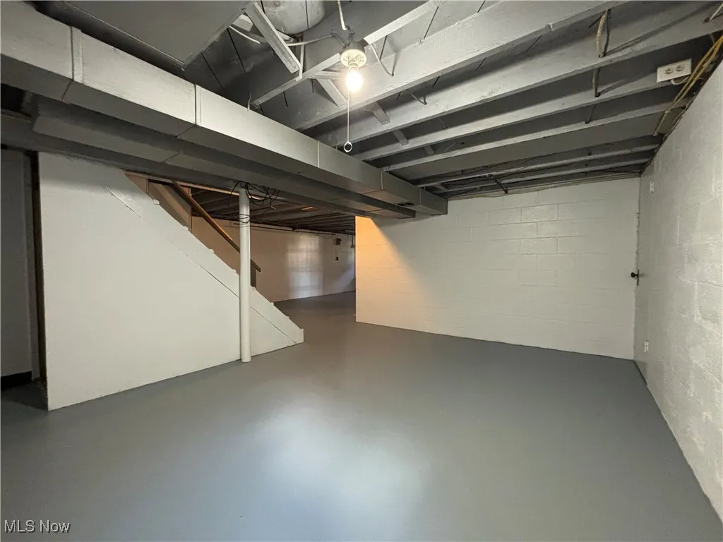 Finished basement featuring stairs