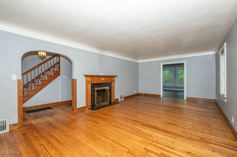 Living room featuring tile fireplace and newly refinished hardwood floors