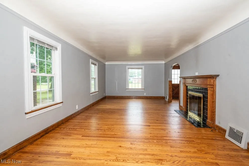 Living room with newly refinished hardwood floors and  fireplace