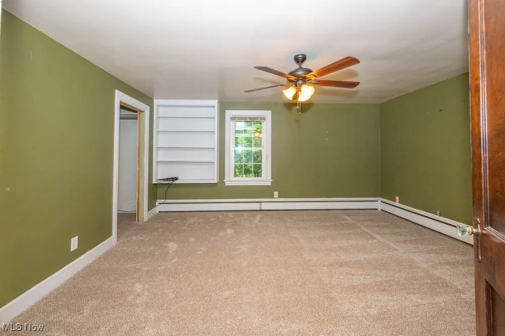 Second bedroom with new carpeting (august 2025) and built in shelves