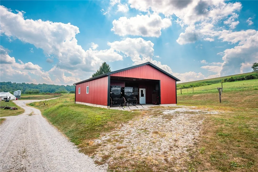 View of pole building featuring a yard and a view of rural / pastoral area