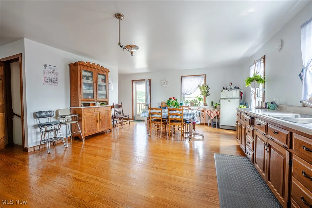 Dining area with light wood-style flooring and healthy amount of natural light