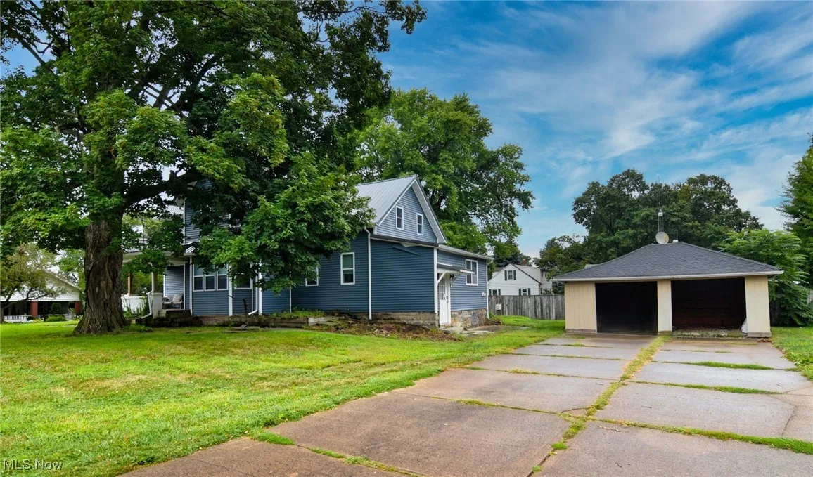 View of home's exterior with an outdoor structure and a garage
