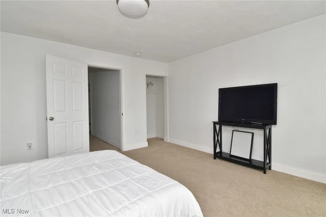 Carpeted bedroom featuring baseboards