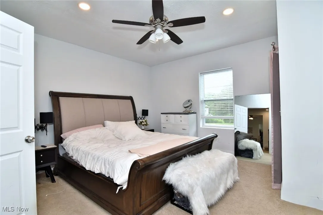 Bedroom featuring light carpet, recessed lighting, and a ceiling fan