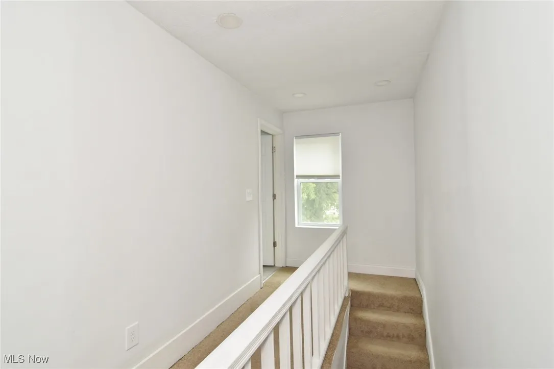 Stairway with carpet flooring and recessed lighting