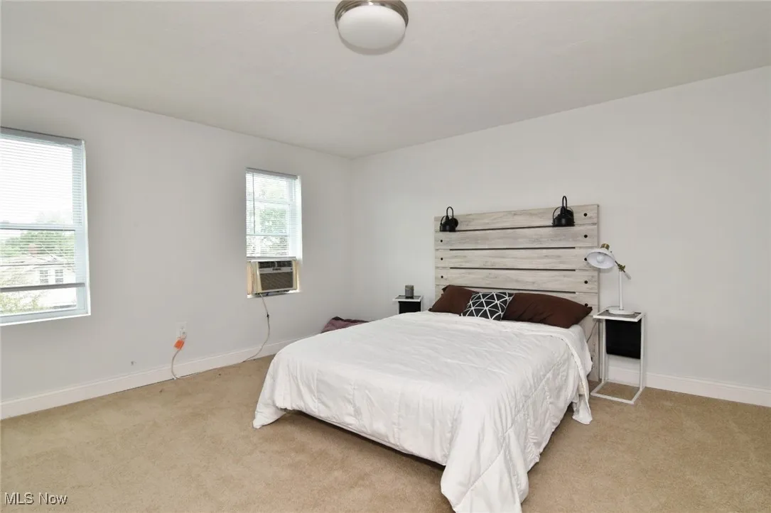 Carpeted bedroom featuring baseboards