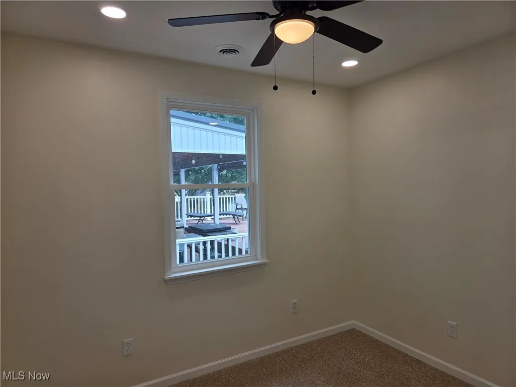 Carpeted empty room featuring recessed lighting and ceiling fan