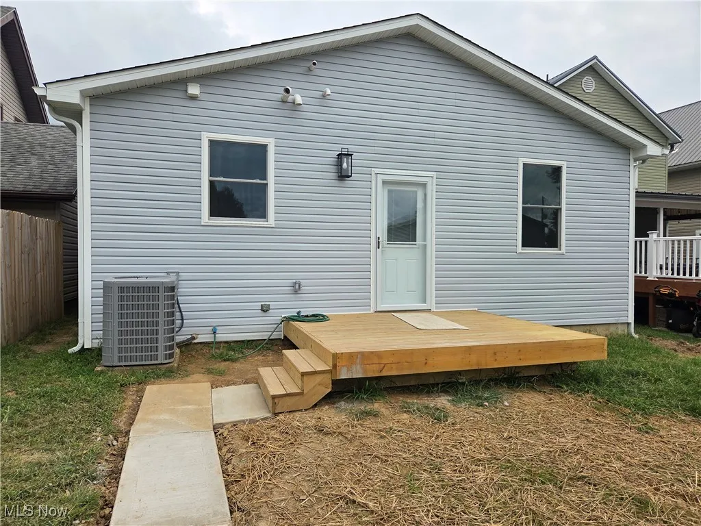 Rear view of property featuring a wooden deck