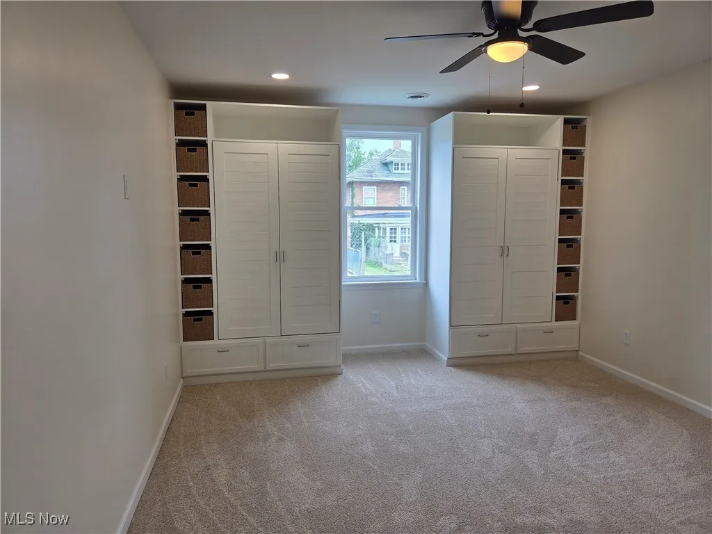 Unfurnished bedroom with light colored carpet, ceiling fan, and recessed lighting