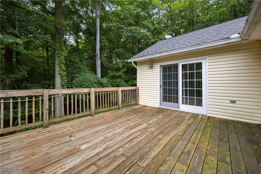 Deck featuring view of wooded area