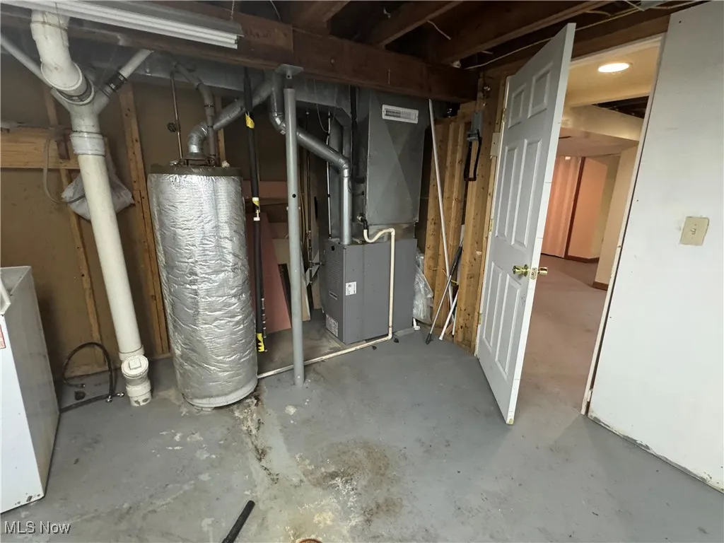 Unfinished basement with heating unit and water heater