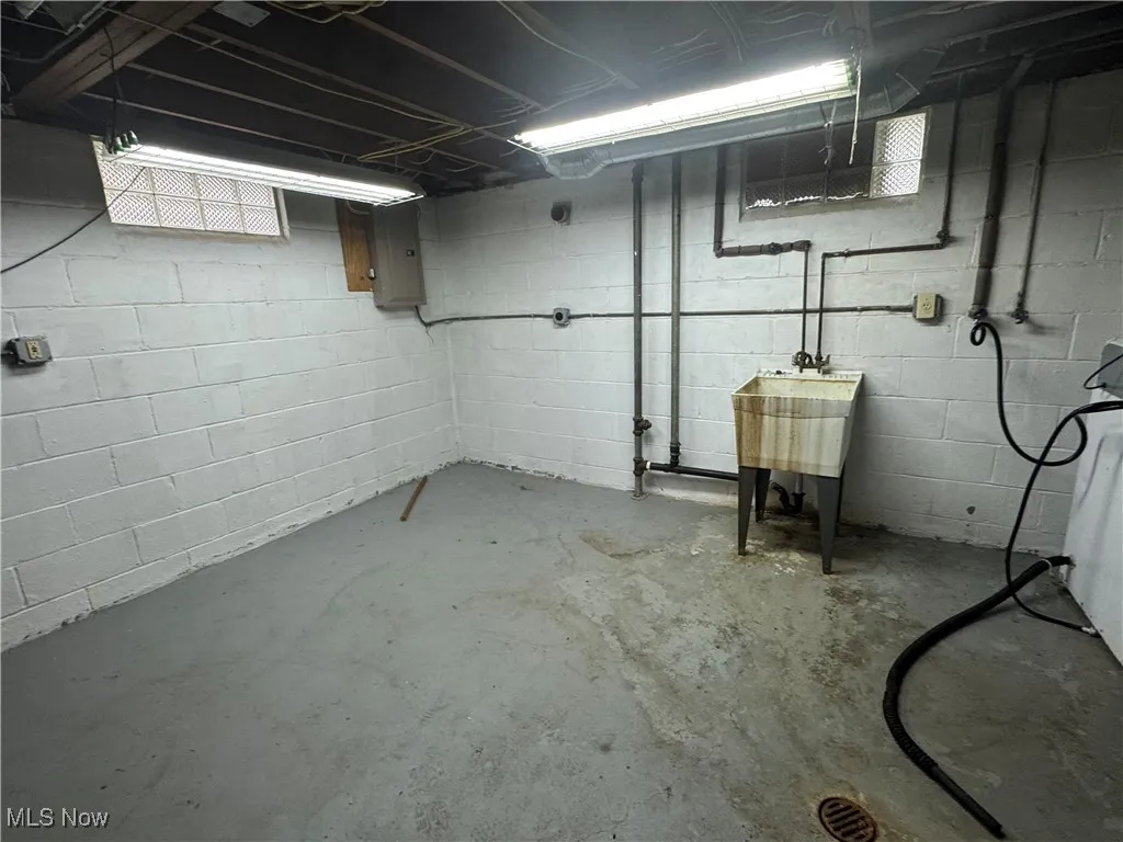 Unfinished basement with electric panel