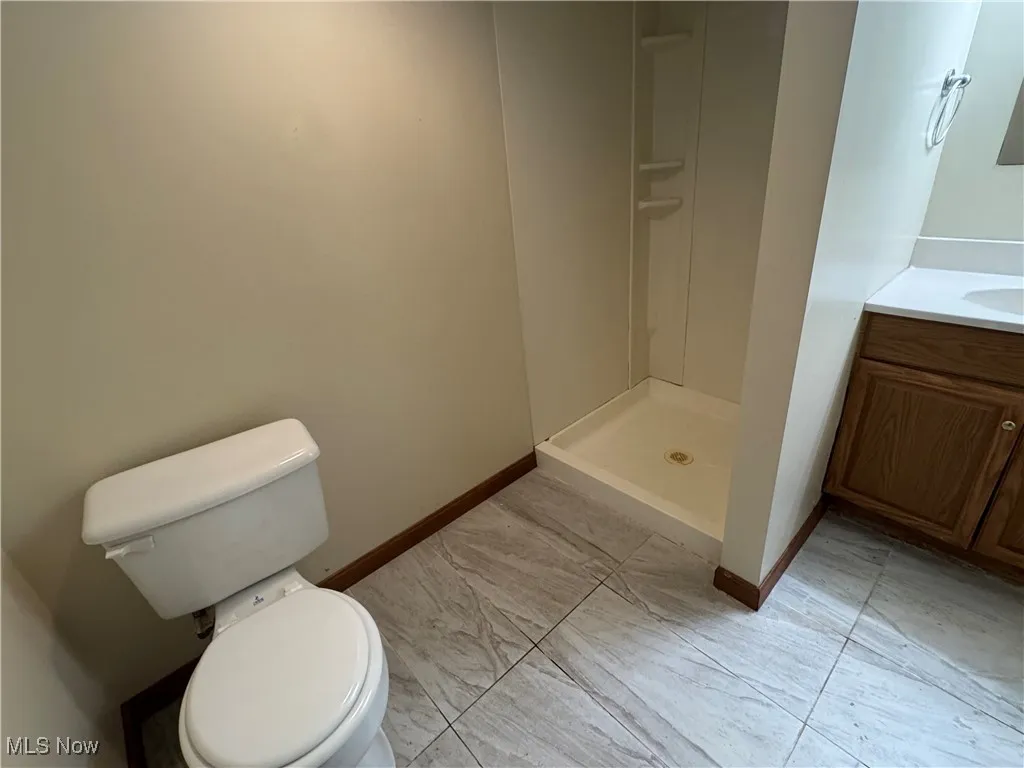 Bathroom with vanity and a shower stall