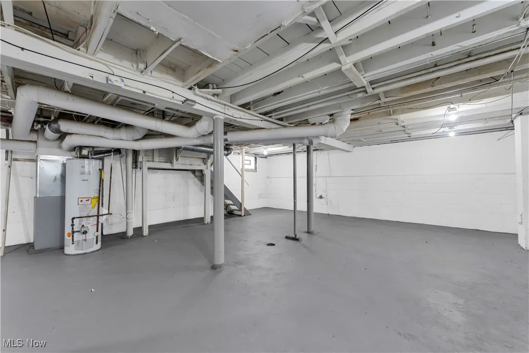 Basement featuring gas water heater and stairway