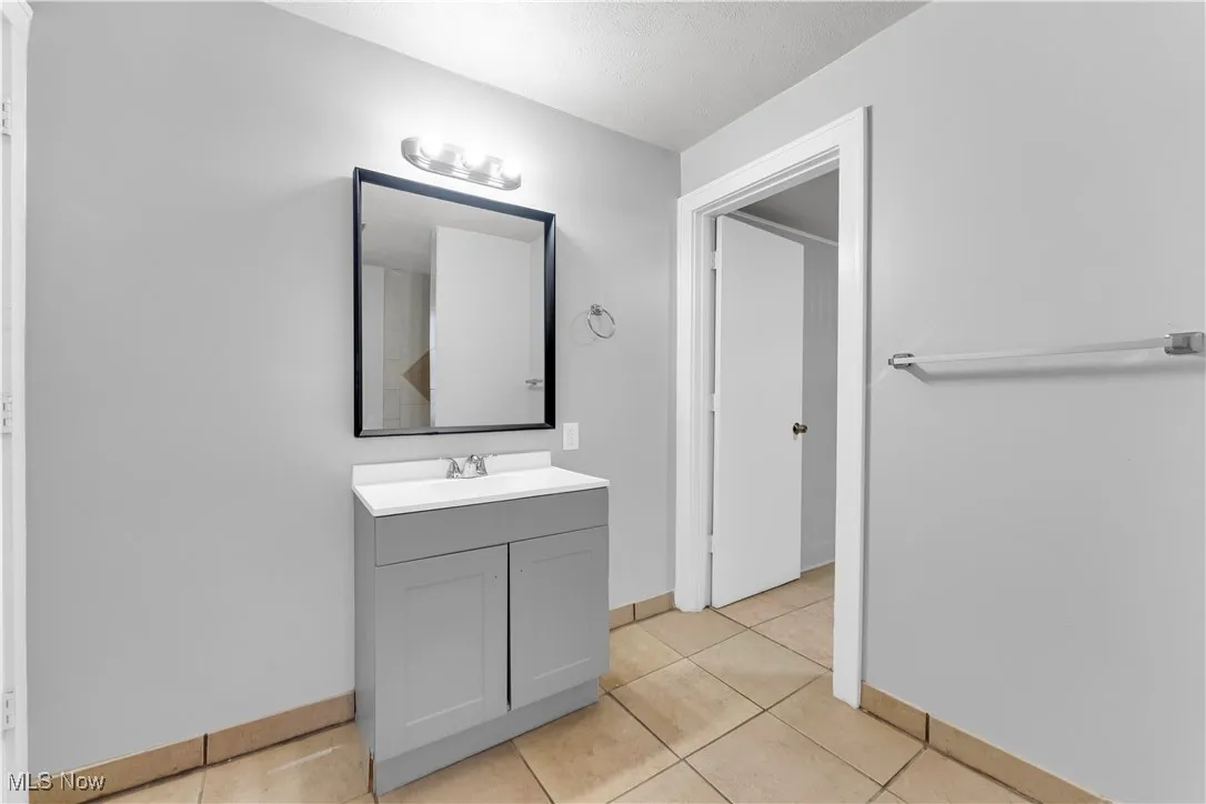 Bathroom with vanity and light tile patterned flooring