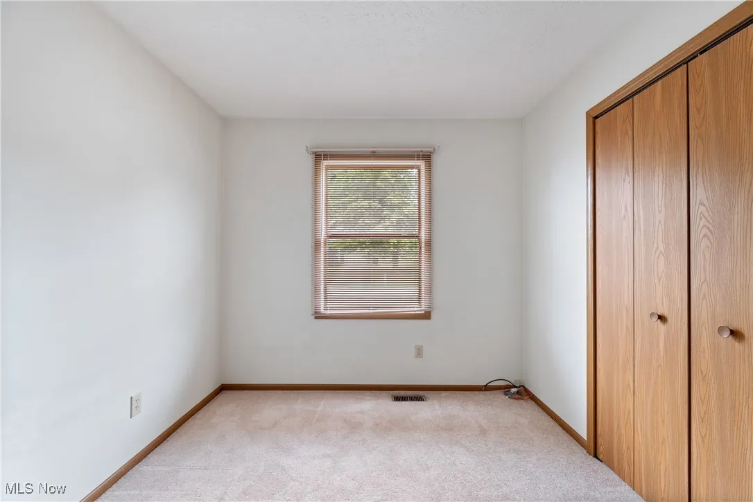Unfurnished bedroom featuring a closet and light colored​​‌​​​​‌​​‌‌​‌‌​​​‌‌​‌​‌​‌​​​‌​​ carpet