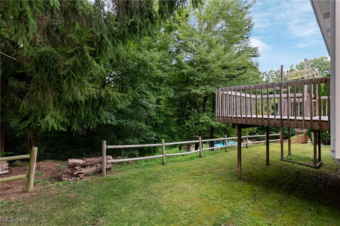 View of yard with a deck and view of scattered trees